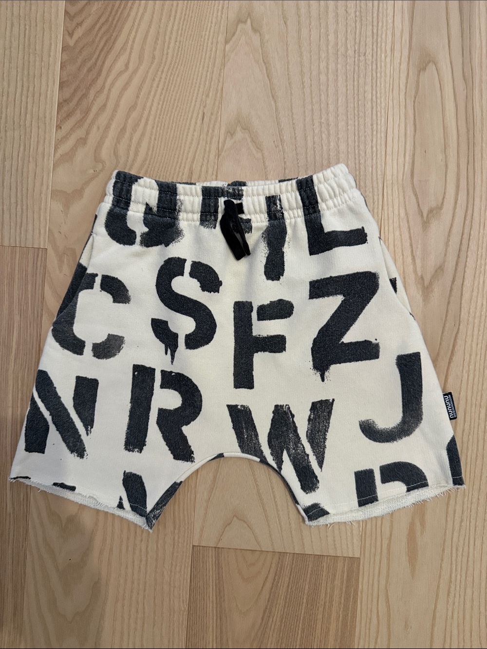 nununu alphabet sweat shorts 100% cotton black and cream. size 6-7. like new.